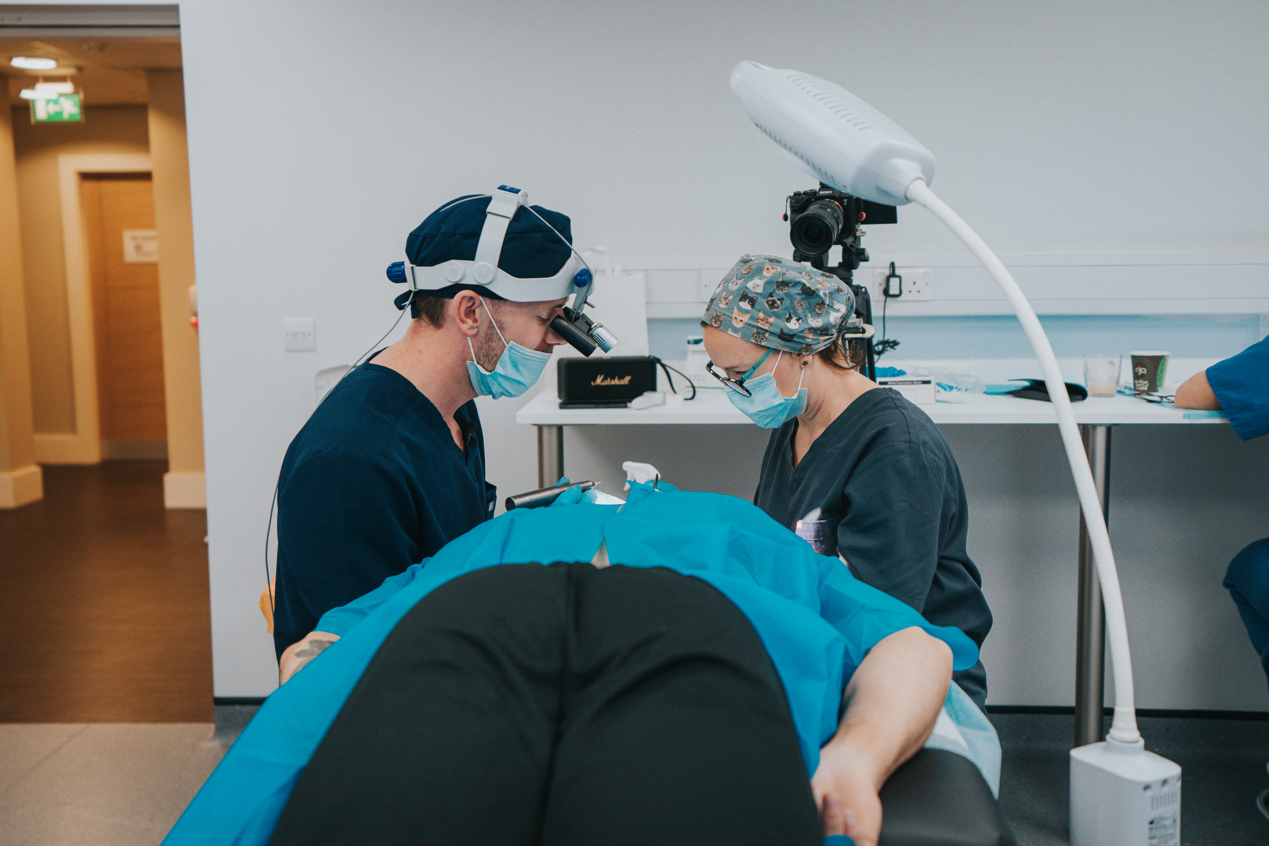 Dr Jamie Harrison performing a hair transplant procedure with his clinical team