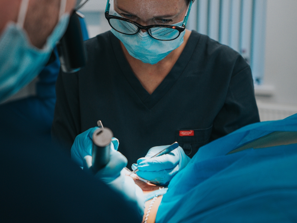 Clinician performing a hair transplant procedure in a clinical setting