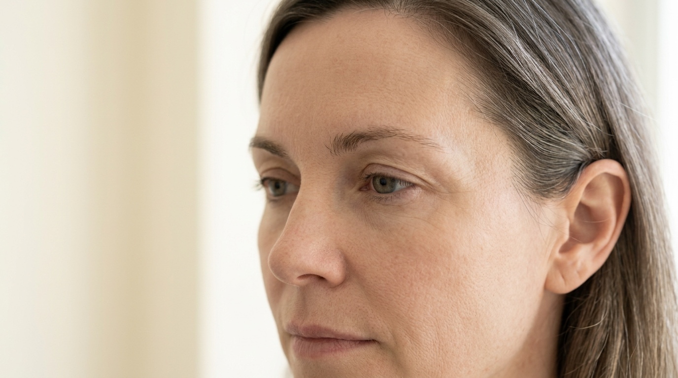Woman in three-quarter profile showing the natural contour of her temple and upper cheek